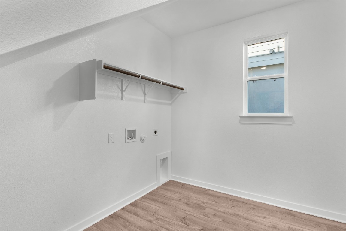 237 Wingstem Way Georgetown, TX 78633 - Photo 6 of 26 Laundry room featuring light wood finished floors, electric dryer hookup, hookup for a washing machine, and gas dryer hookup