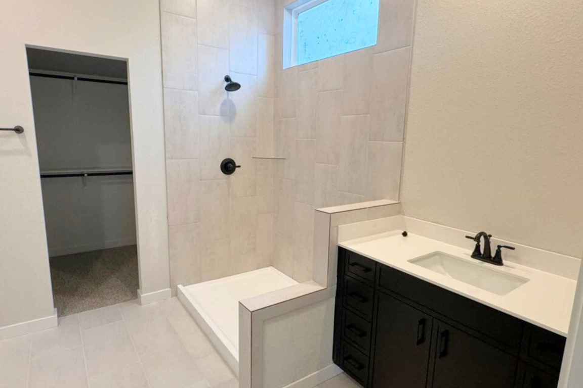 237 Wingstem Way Georgetown, TX 78633 - Photo 6 of 40 a bathroom with a sink a mirror and a shower