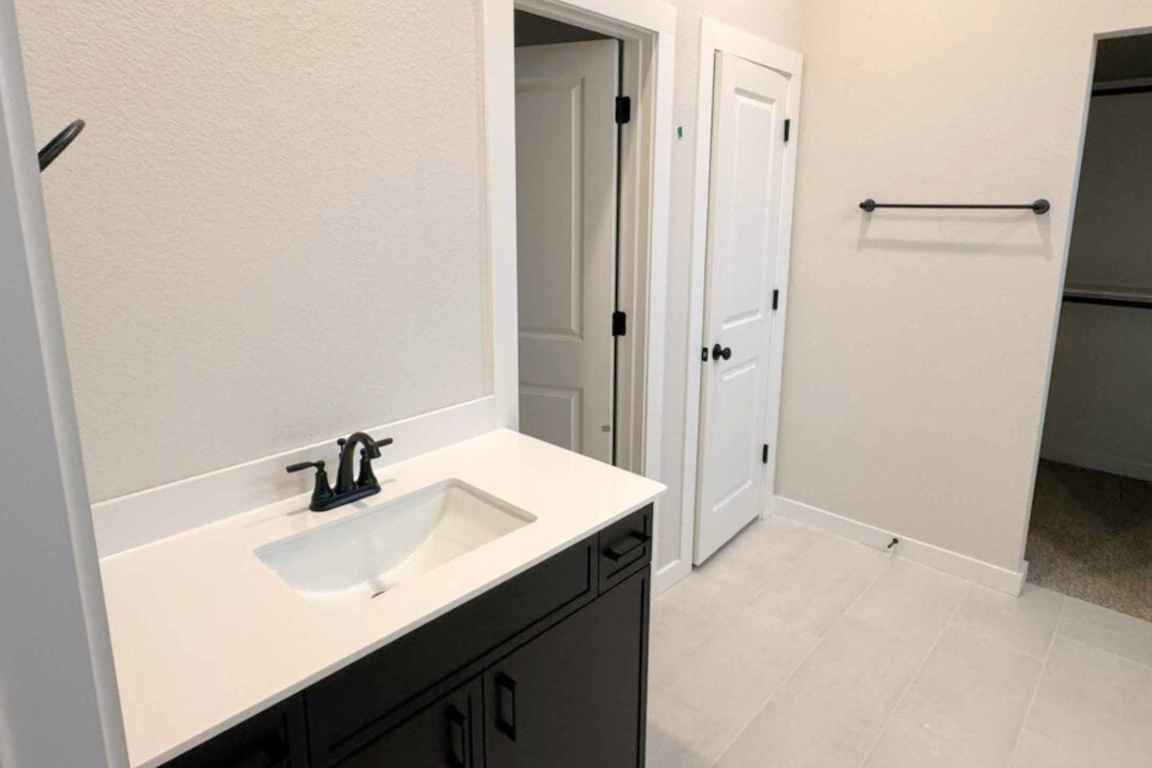 237 Wingstem Way Georgetown, TX 78633 - Photo 7 of 40 a bathroom with a sink a mirror and vanity