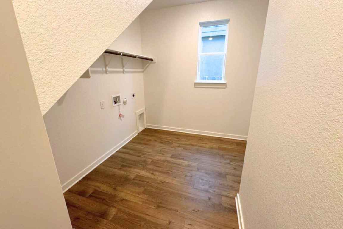 237 Wingstem Way Georgetown, TX 78633 - Photo 8 of 40 Washroom with gas dryer hookup, dark wood-style floors, hookup for an electric dryer, and hookup for a washing machine