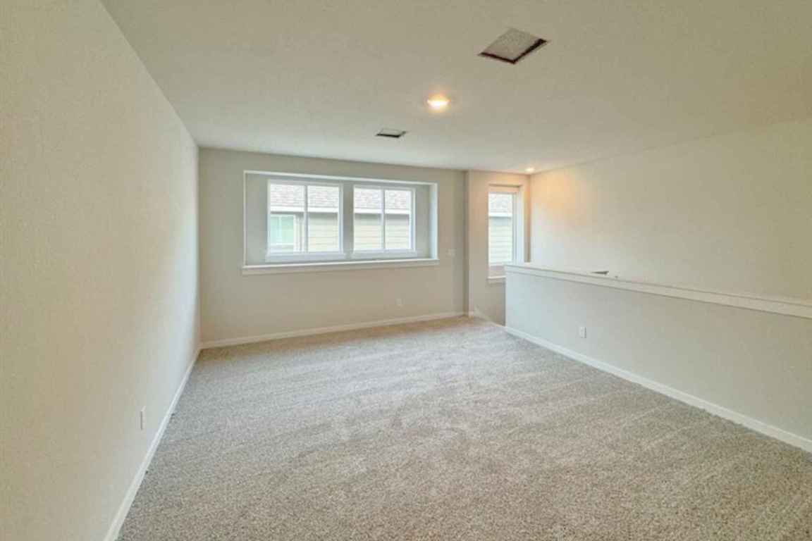 237 Wingstem Way Georgetown, TX 78633 - Photo 9 of 40 an empty room with windows