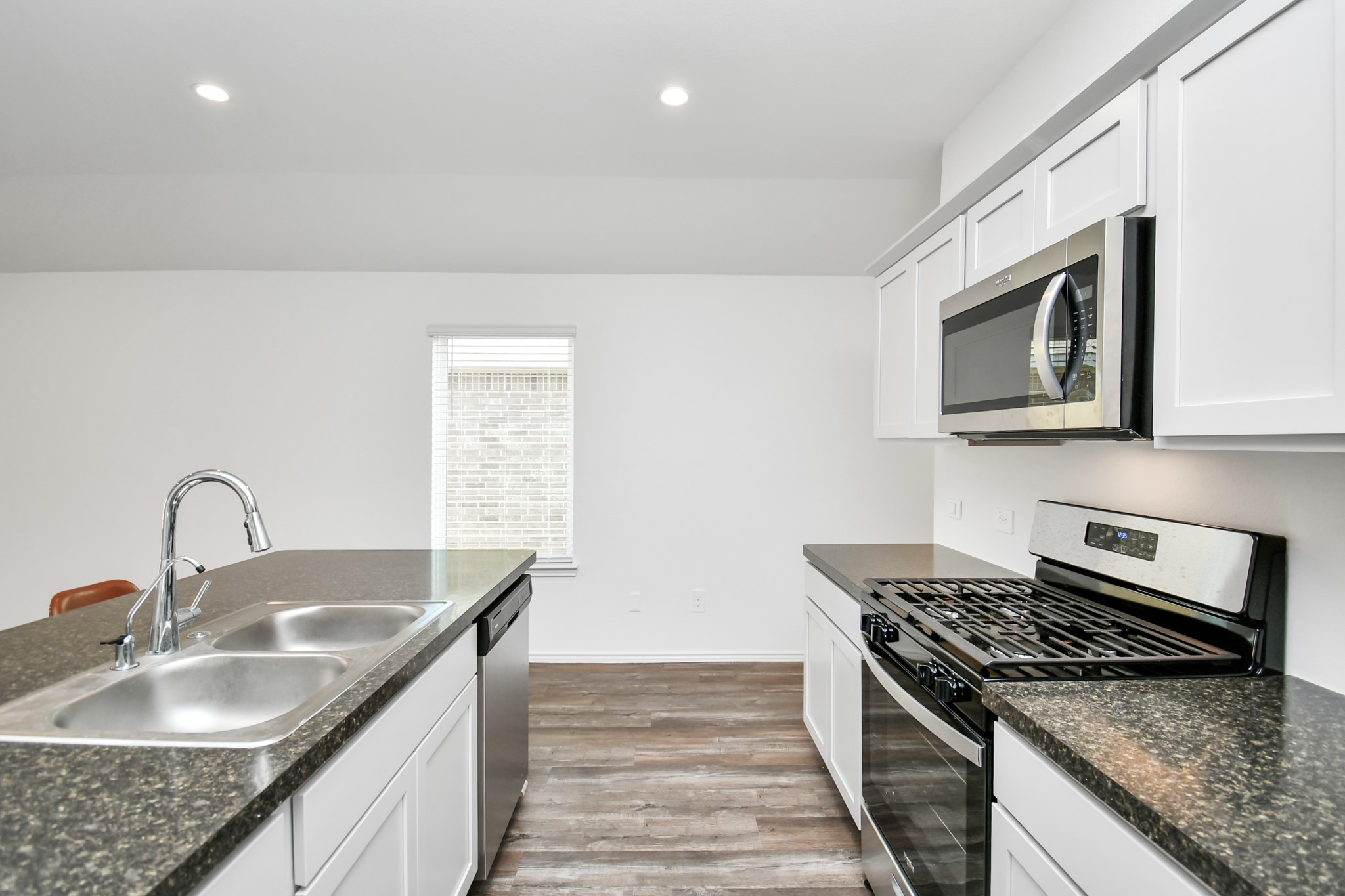 5315 Castlebury Meadows Dr Spring Spring, TX 77373 - Photo 9 of 39 a kitchen with sink a microwave and stove