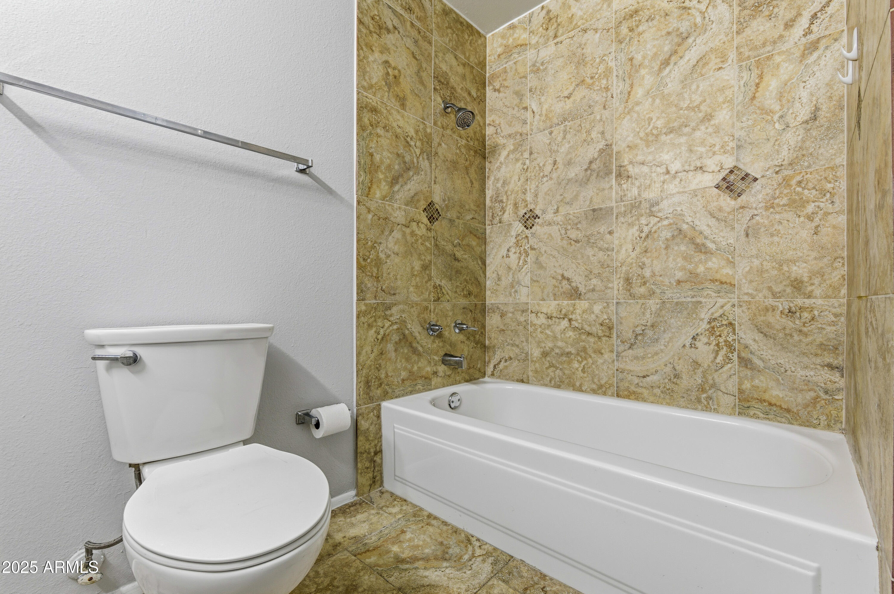 4808 North 71st Lane Phoenix, AZ 85033 - Photo 10 of 20 a bathroom with a toilet and a bathtub