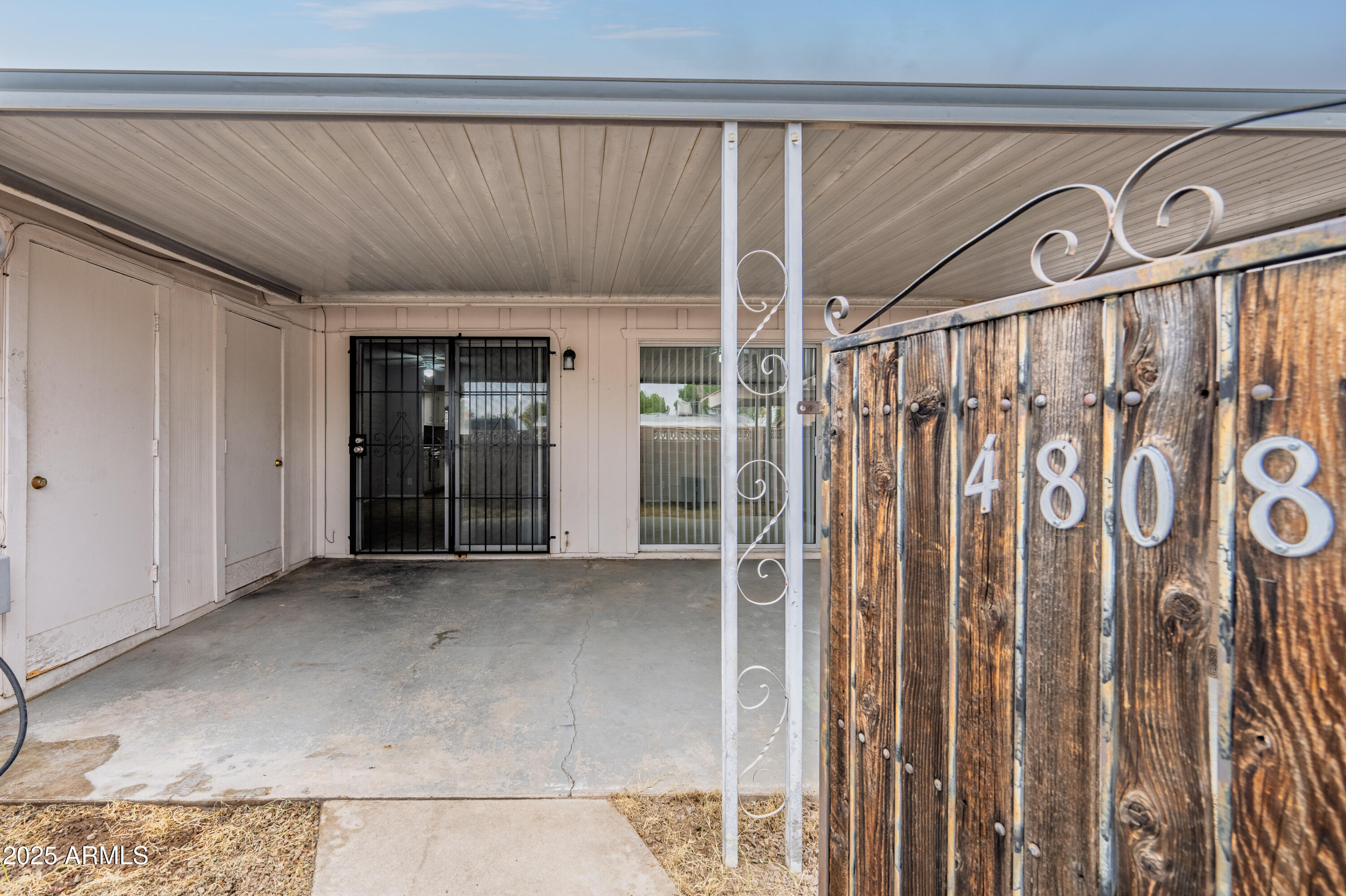 4808 North 71st Lane Phoenix, AZ 85033 - Photo 16 of 20 a view of an entryway with wooden floor