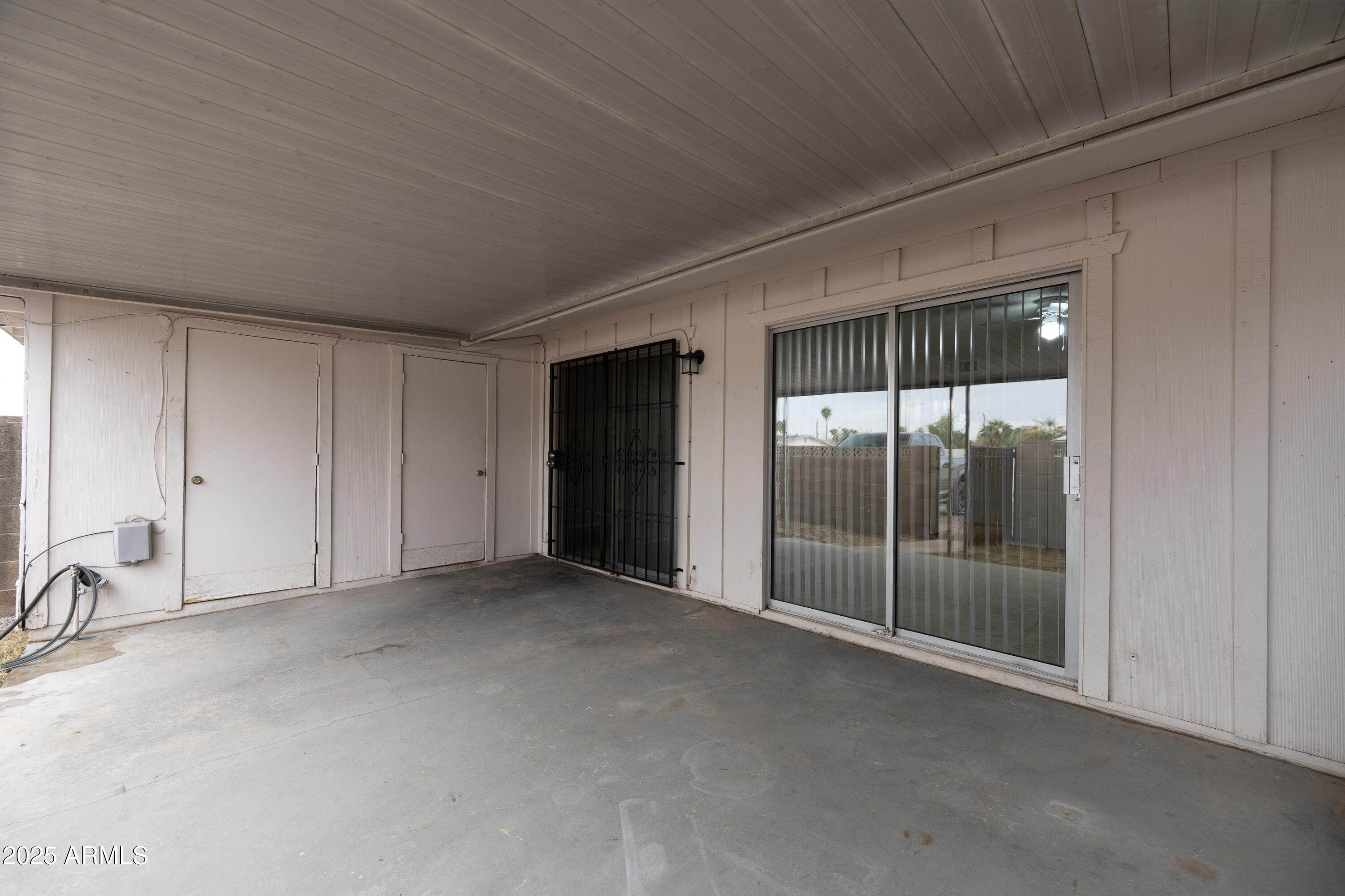 4808 North 71st Lane Phoenix, AZ 85033 - Photo 18 of 20 an empty room with sliding glass door