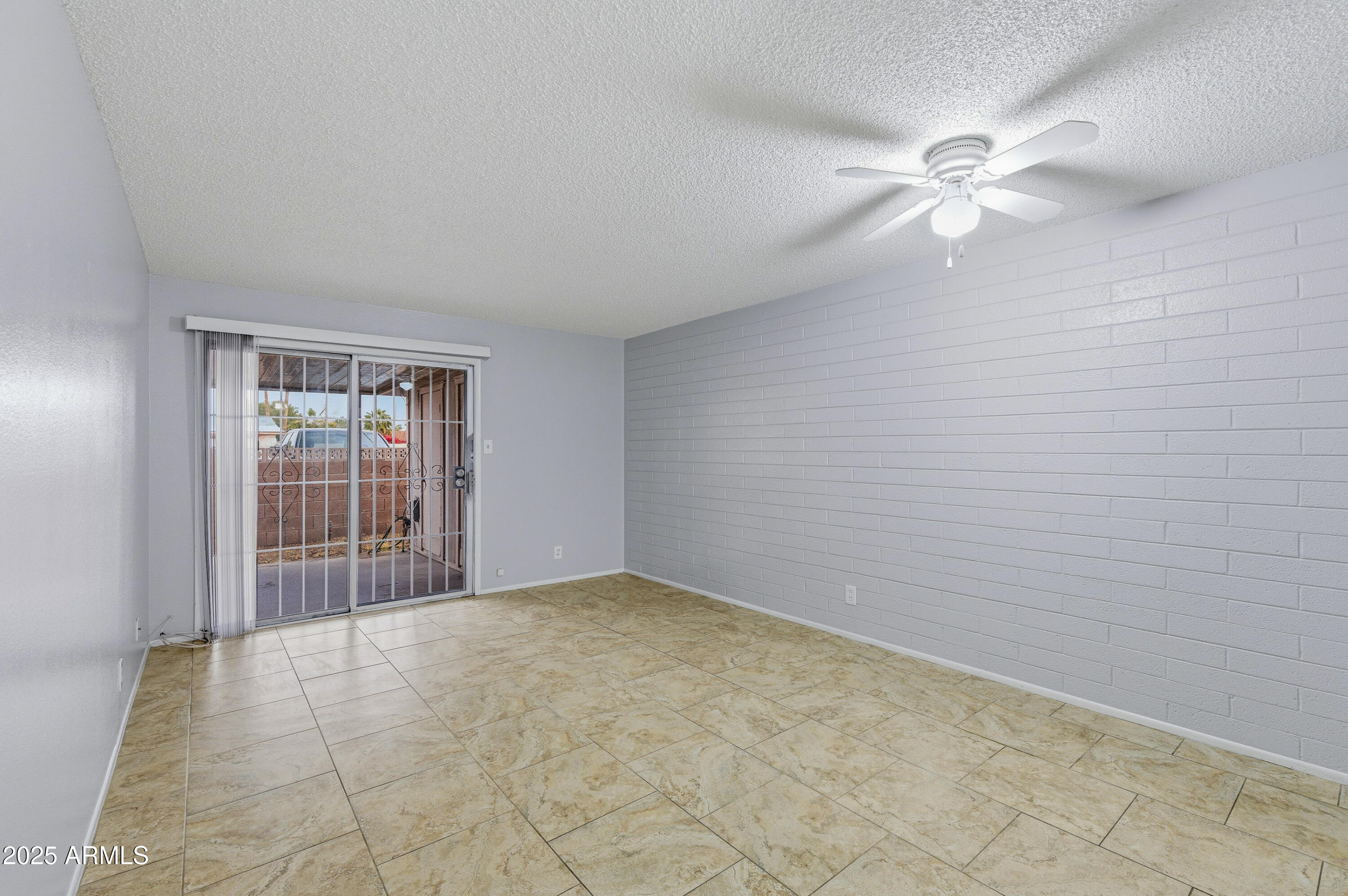 4808 North 71st Lane Phoenix, AZ 85033 - Photo 5 of 20 a view of an empty room with a window