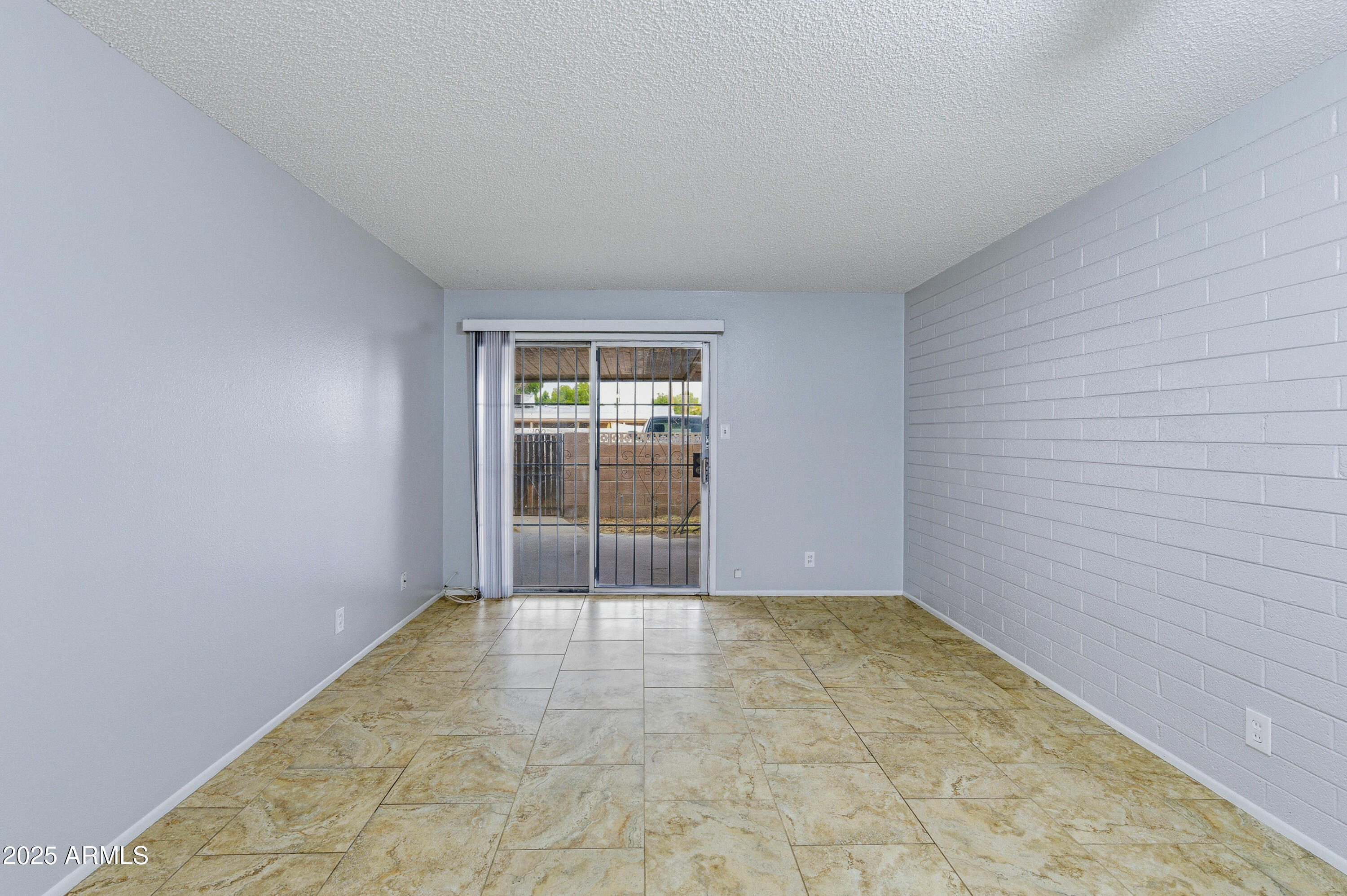 4808 North 71st Lane Phoenix, AZ 85033 - Photo 7 of 20 an empty room with windows
