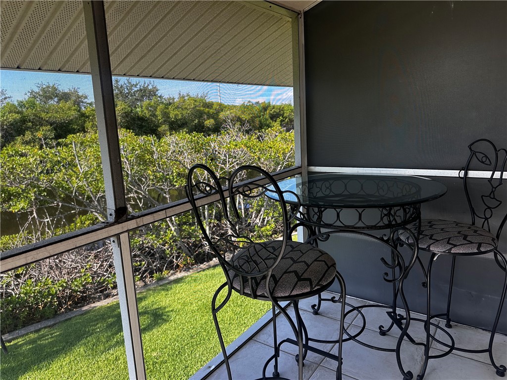 1815 Robalo Drive, Unit C201 Vero Beach, FL 32960 - Photo 10 of 31 a view of a chairs and table in patio