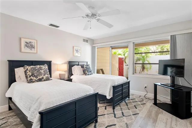 a bedroom with a large bed and a chandelier