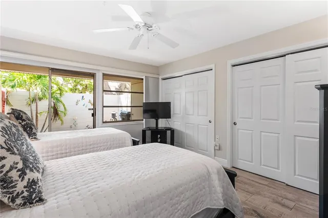 a bedroom with two beds and painting on the wall