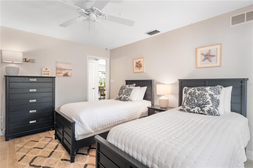 6005 Midnight Pass Road, Unit S4 Sarasota, FL 34242 - Photo 21 of 34 a bedroom with two beds and painting on the wall