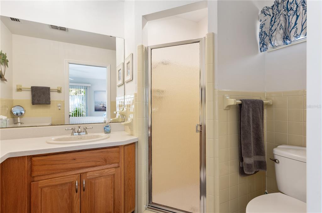 6005 Midnight Pass Road, Unit S4 Sarasota, FL 34242 - Photo 24 of 34 a bathroom with a sink toilet and shower