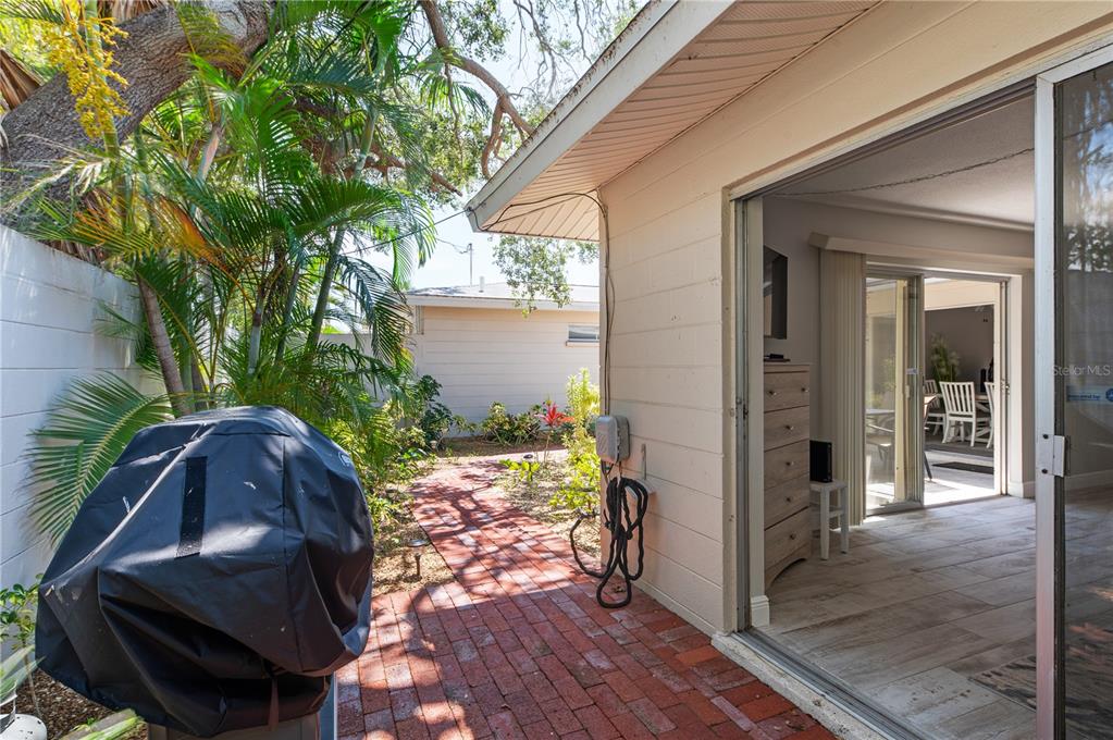6005 Midnight Pass Road, Unit S4 Sarasota, FL 34242 - Photo 25 of 34 a view of a porch with furniture and yard