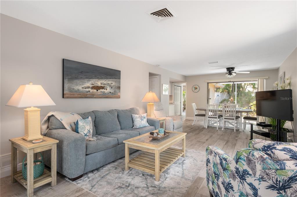 6005 Midnight Pass Road, Unit S4 Sarasota, FL 34242 - Photo 5 of 34 a living room with furniture and a flat screen tv