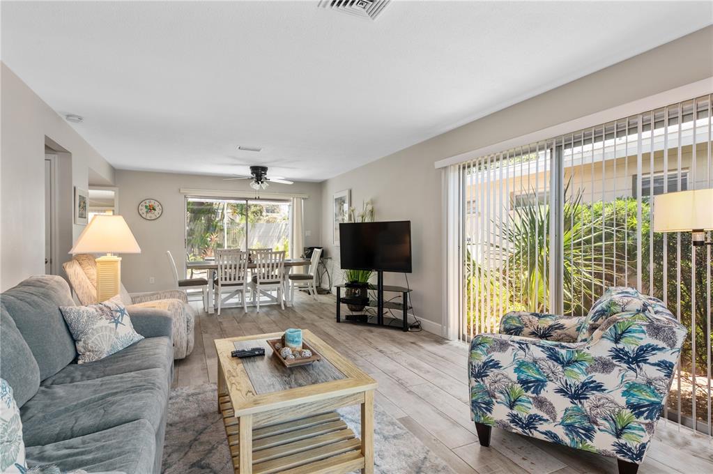 6005 Midnight Pass Road, Unit S4 Sarasota, FL 34242 - Photo 6 of 34 a living room with furniture and a flat screen tv