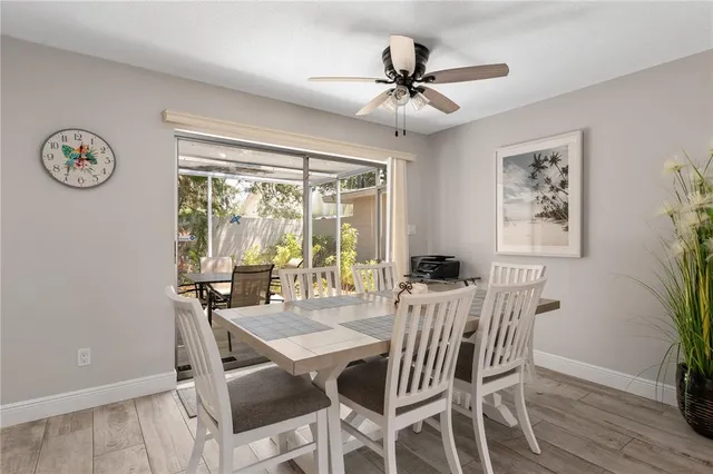 a view of a dining room with furniture wooden floor and a chandelier