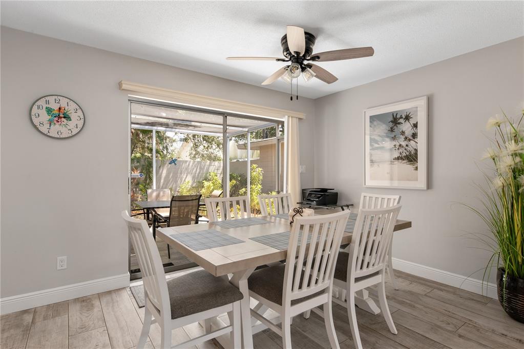 6005 Midnight Pass Road, Unit S4 Sarasota, FL 34242 - Photo 9 of 34 a view of a dining room with furniture window and wooden floor