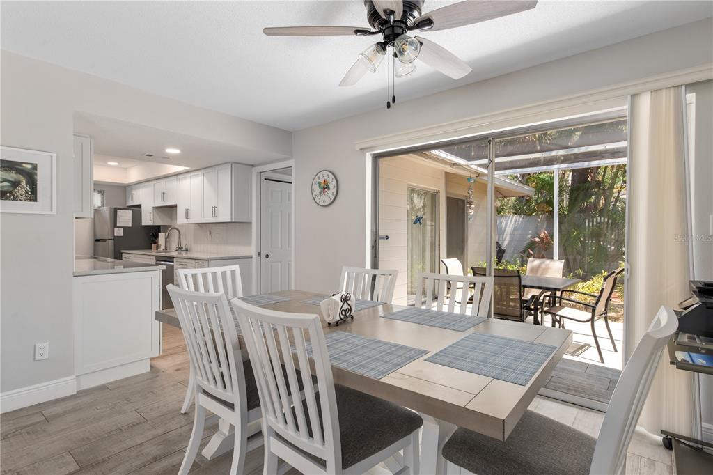 6005 Midnight Pass Road, Unit S4 Sarasota, FL 34242 - Photo 10 of 34 a view of a dining room with furniture wooden floor and a chandelier