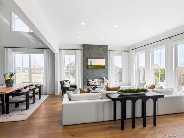 a living room with furniture and large windows