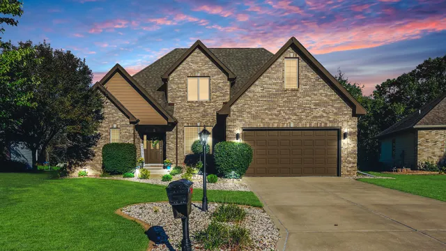 a front view of a house with a yard and garage
