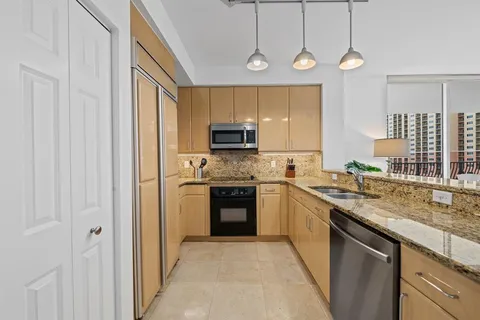 a kitchen with a sink stove and microwave