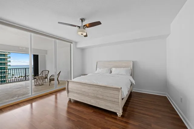 a bedroom with a bed and a view of living room