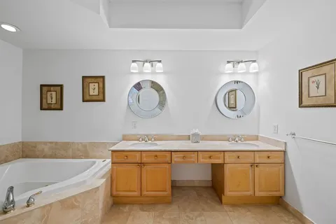 a bathroom with a granite countertop sink mirror bathtub and shower