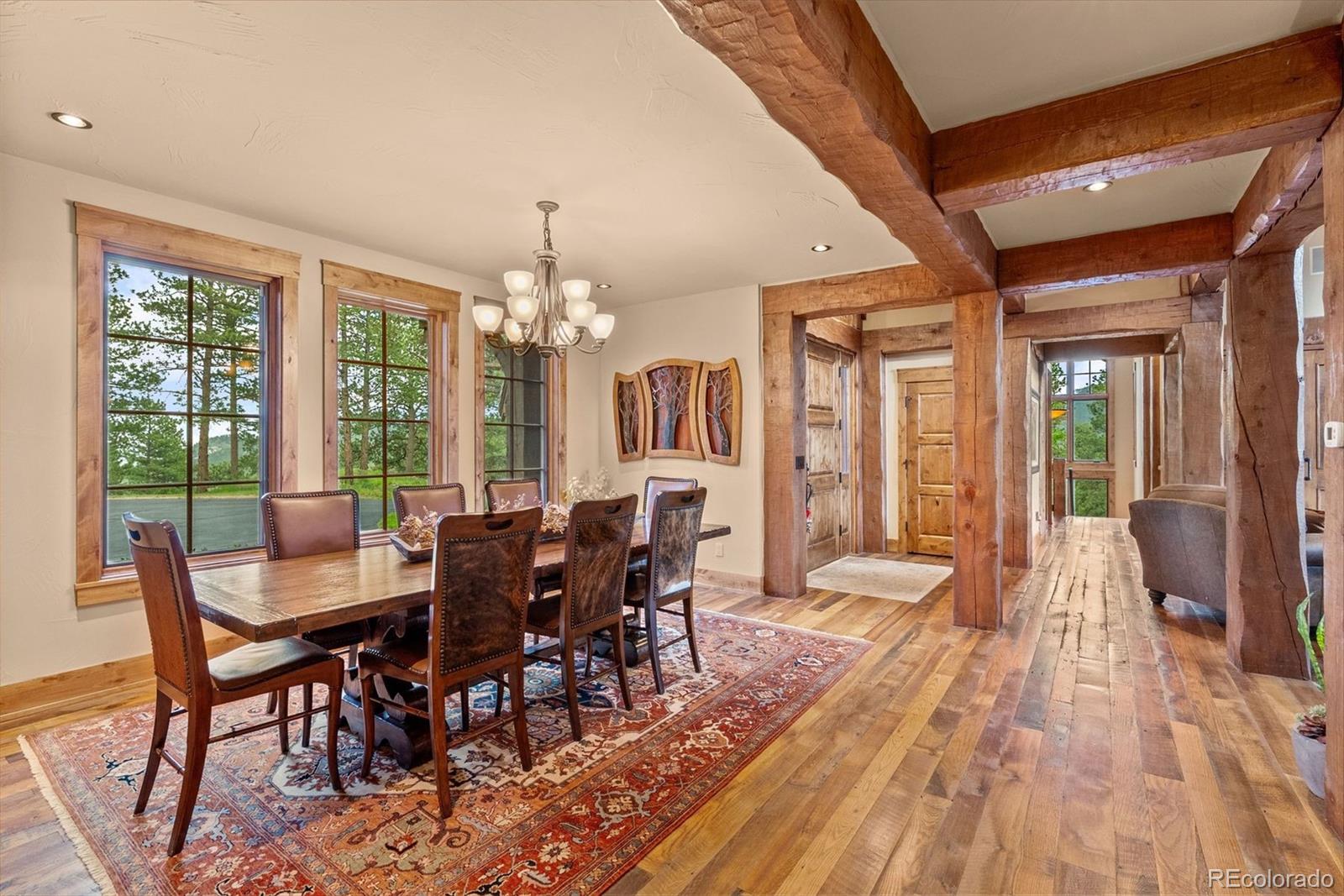 2929 Highlands View Road Evergreen, CO 80439 - Photo 14 of 50 a view of a dining room with furniture window and wooden floor