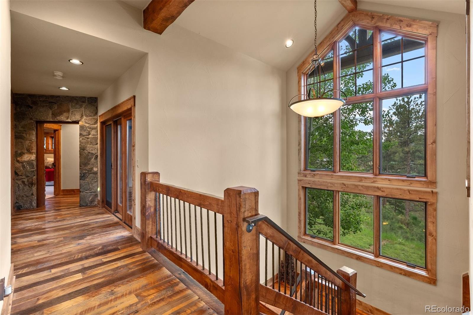 2929 Highlands View Road Evergreen, CO 80439 - Photo 32 of 50 a view of a porch with wooden floor and windows
