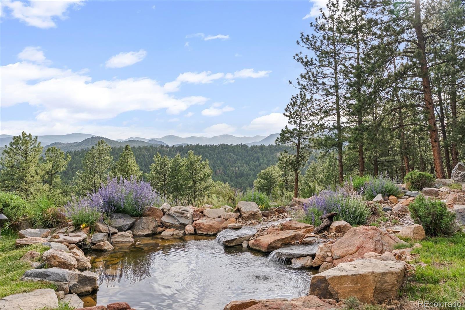 2929 Highlands View Road Evergreen, CO 80439 - Photo 47 of 50 a view of a backyard with sitting area