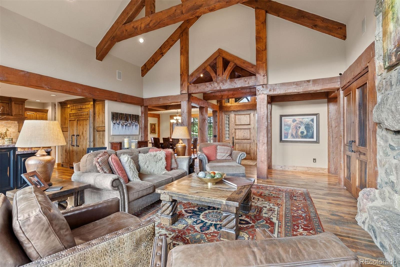 2929 Highlands View Road Evergreen, CO 80439 - Photo 5 of 50 a living room with furniture a rug and a chandelier
