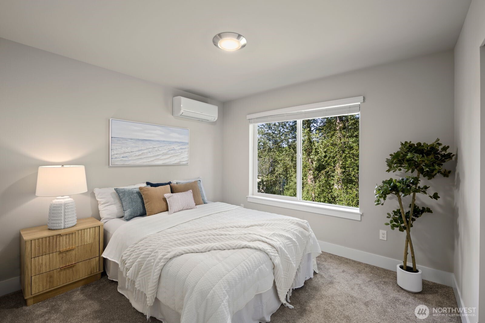 826 238th Place Southeast, Unit F Bothell, WA 98021 - Photo 14 of 39 a bedroom with a bed and a potted plant