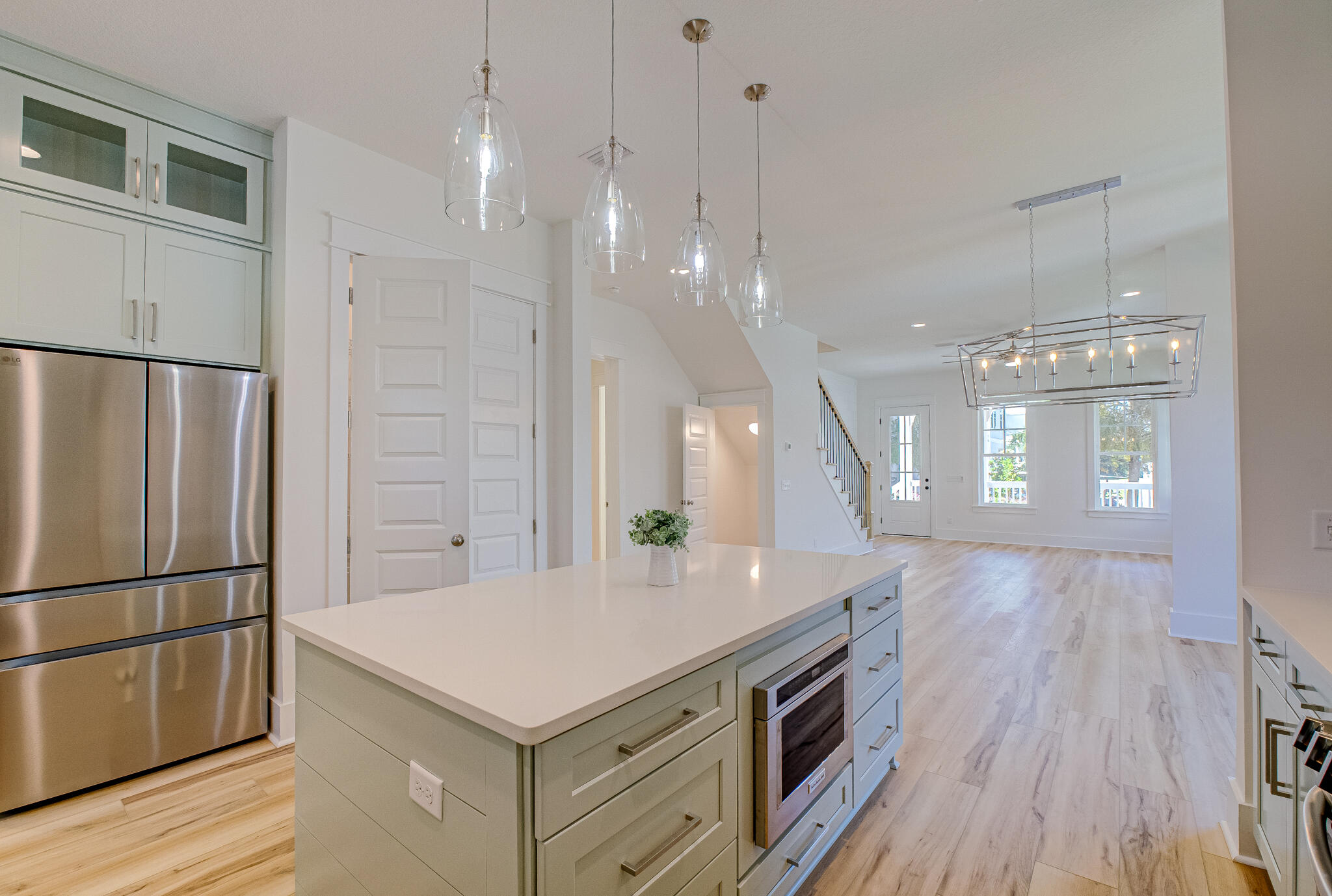 174 Grande Pointe Cir Inlet Beach Inlet Beach, FL 32461 - Photo 13 of 55 a kitchen with a center island wooden floor stainless steel appliances and windows