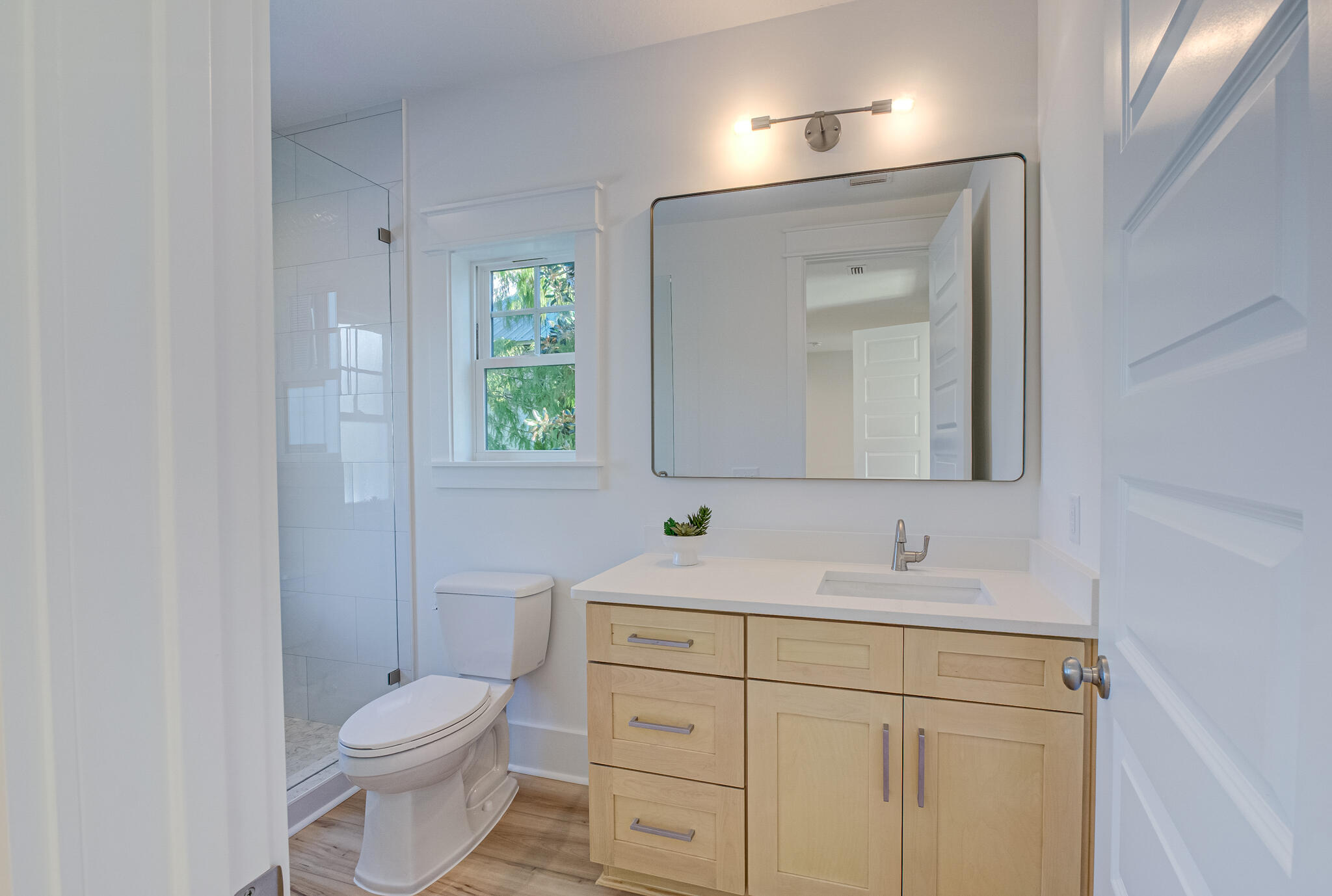 174 Grande Pointe Cir Inlet Beach Inlet Beach, FL 32461 - Photo 34 of 55 a bathroom with a toilet sink vanity and mirror