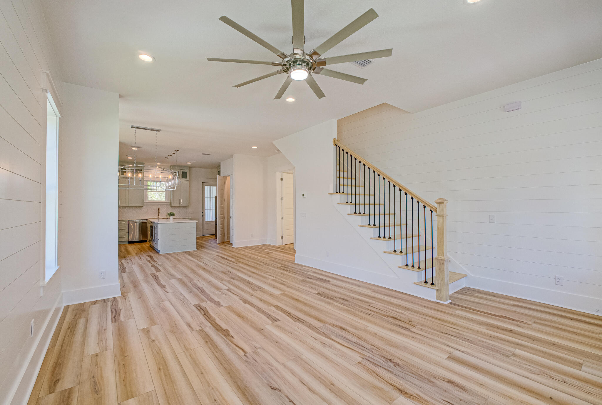 174 Grande Pointe Cir Inlet Beach Inlet Beach, FL 32461 - Photo 6 of 55 a view of a livingroom with wooden floor and a ceiling fan