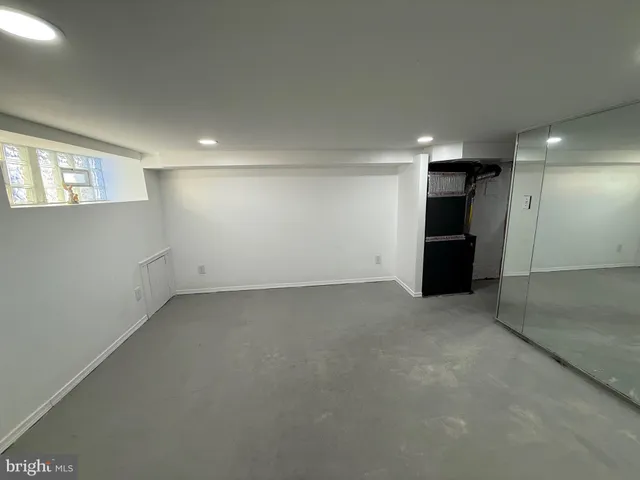 an empty room with a empty space and windows