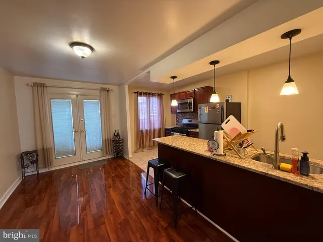 a view of a kitchen counter space and wooden floor