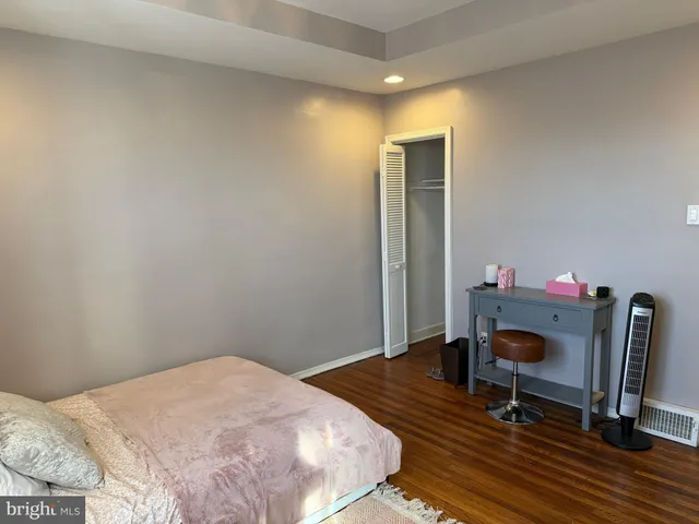 a bedroom with a bed and a workspace