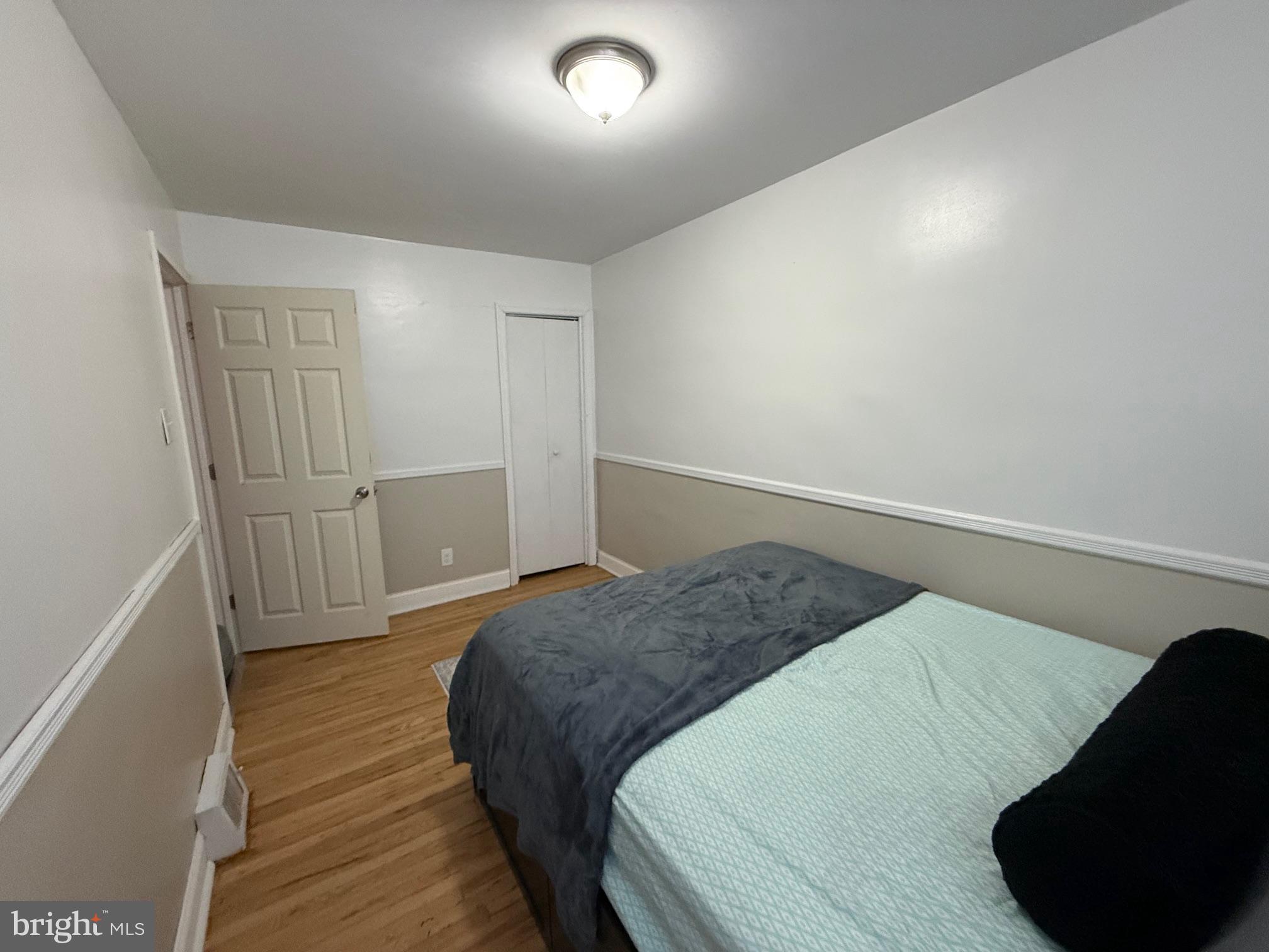 6234 Cottage Street Philadelphia, PA 19135 - Photo 9 of 16 a bedroom with a bed and wooden floor