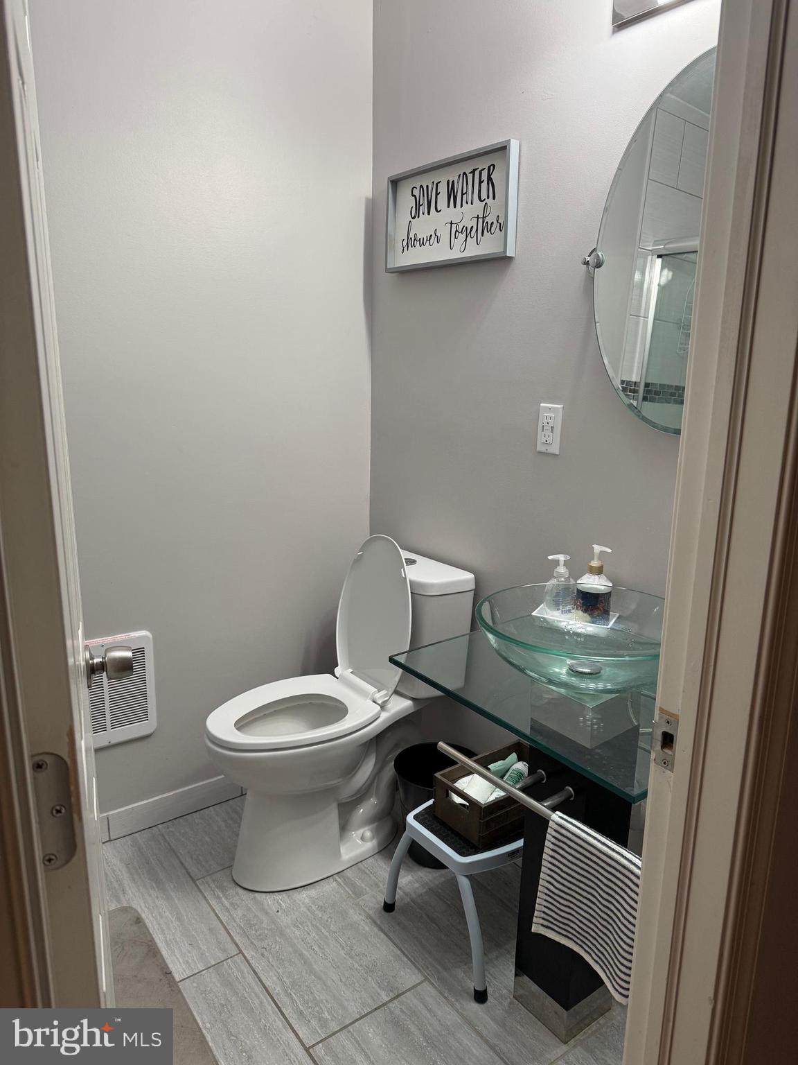6234 Cottage Street Philadelphia, PA 19135 - Photo 10 of 16 a bathroom with a toilet and a mirror
