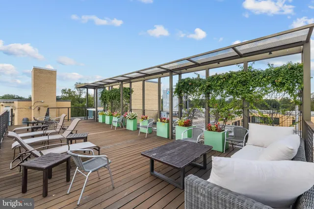 a balcony with furniture and a potted plant
