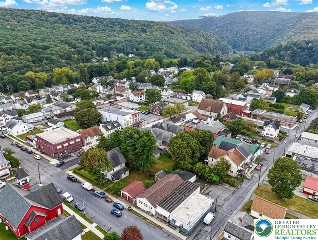 an aerial view of residential houses with outdoor space and street view