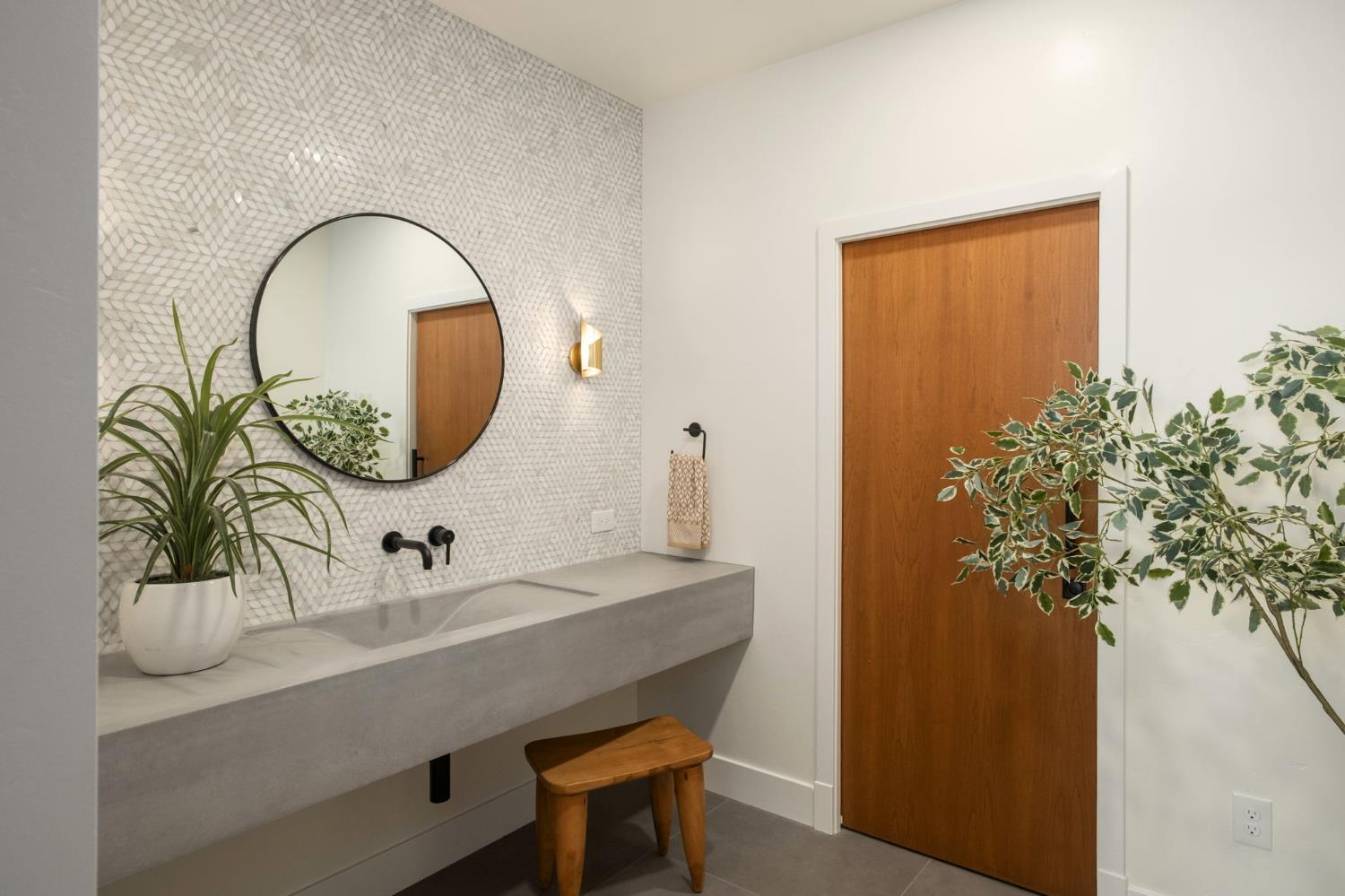 1230 West Moraga Road Fresno, CA 93711 - Photo 28 of 66 a bathroom with a sink a mirror and a potted plant