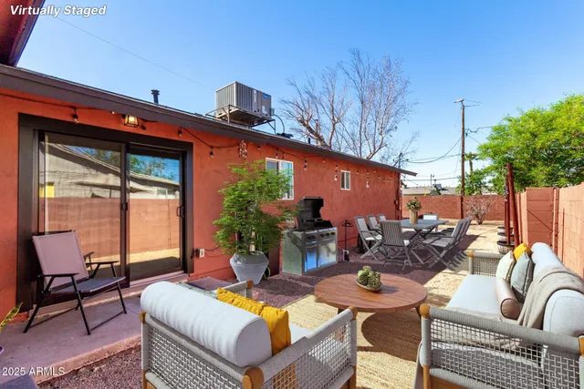 a view of a patio with couches table and chairs and potted plants