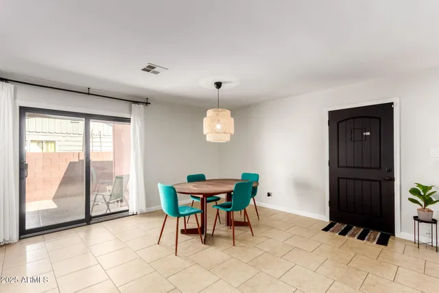 a dining room with furniture and a window