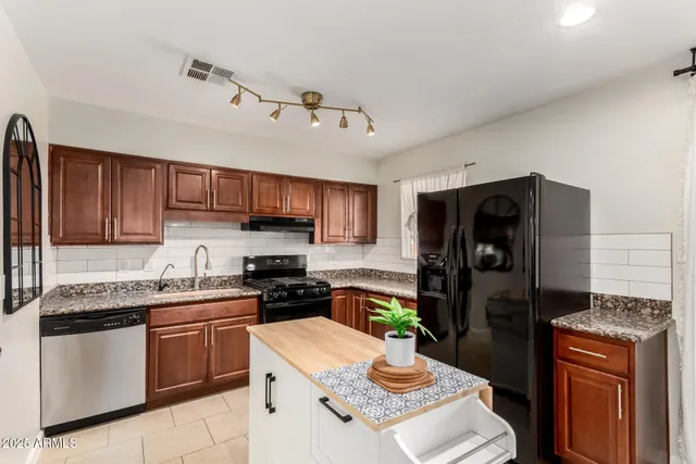 a kitchen with a refrigerator stove and sink