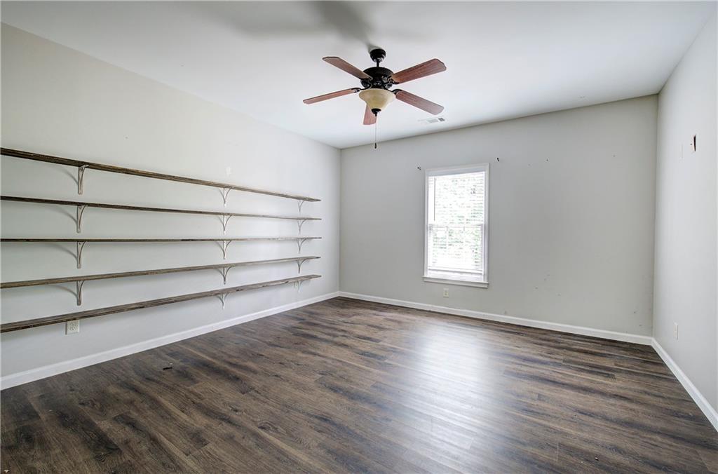 561 Holland Road Dallas, GA 30157 - Photo 35 of 48 a view of an empty room with a window and wooden floor