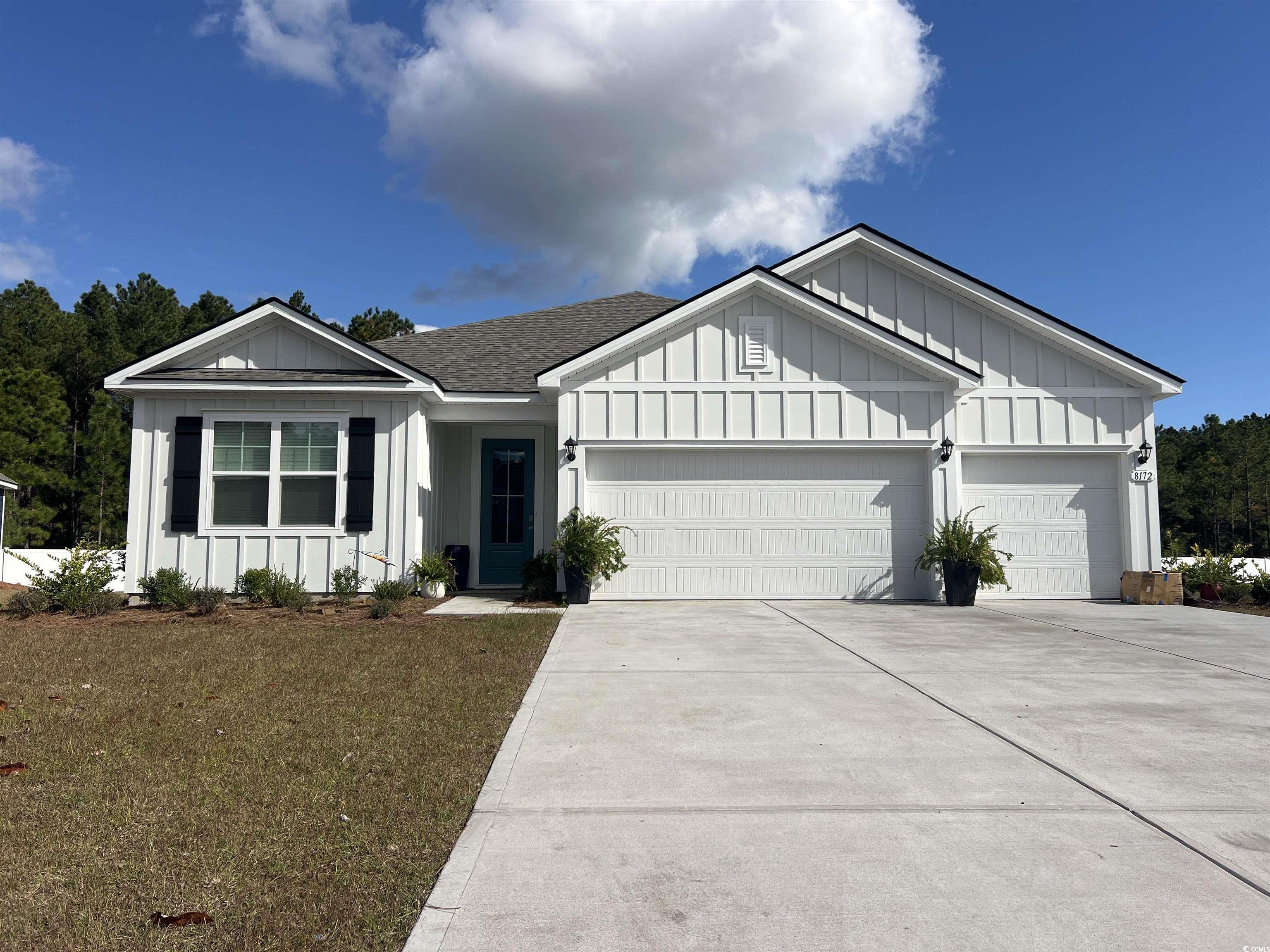 8172 Bear Claw Way Conway, SC 29526 - Photo 1 of 1 View of front of home with board and batten siding, a shingled roof, driveway, and an attached garage