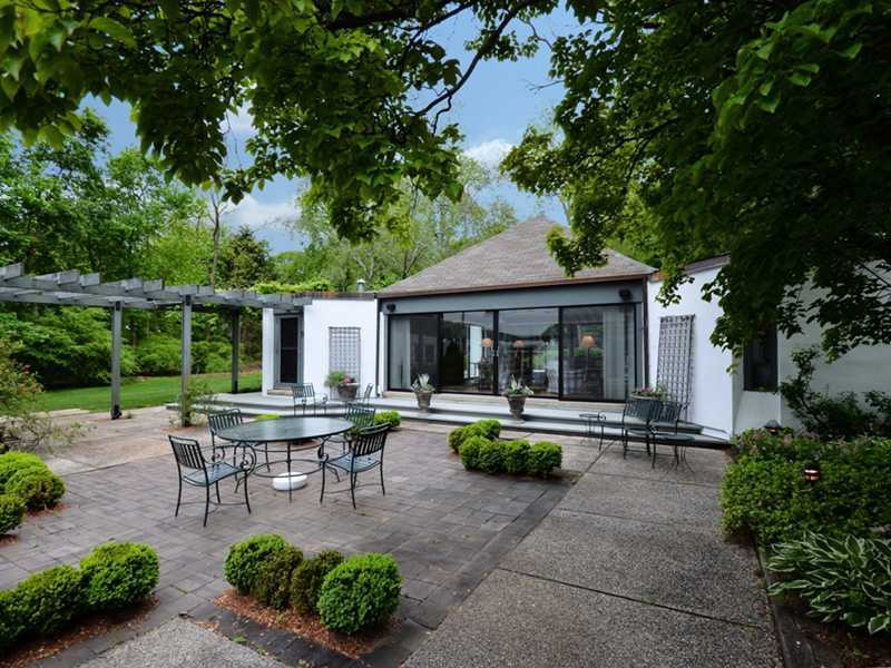 331 Hollow Tree Ridge Road Darien, CT 06820 - Photo 12 of 19 a white bench sitting in front of house with a yard