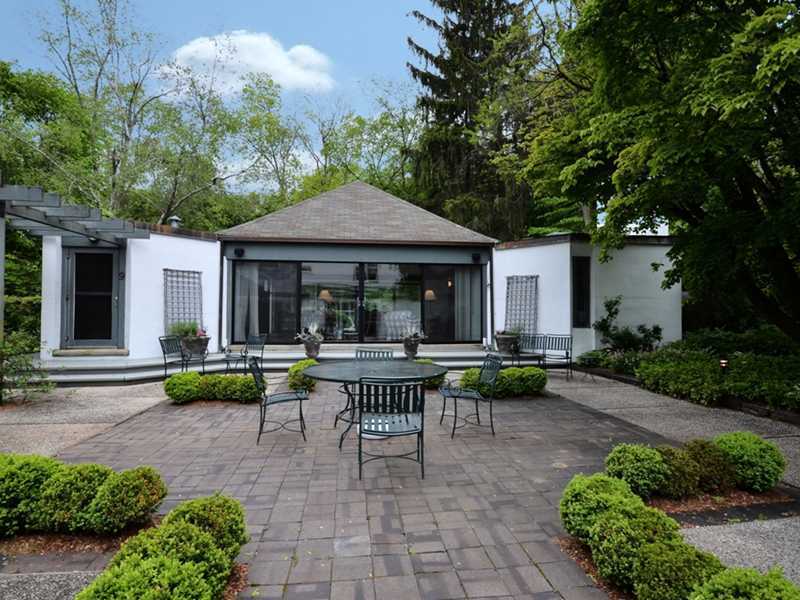 331 Hollow Tree Ridge Road Darien, CT 06820 - Photo 13 of 19 a view of a house with backyard sitting area and garden